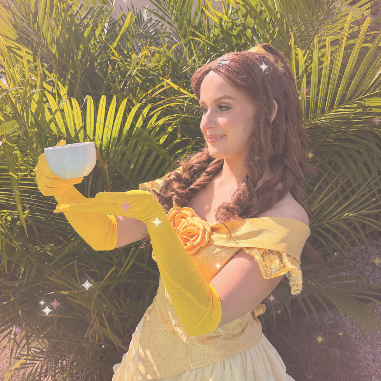 Belle princess performer in a golden ballgown leading princess training with children